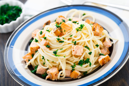 Delicious salmon pasta with parsley on a plateの写真素材