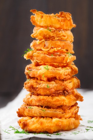 Homemade crunchy fried onion rings on a parchmentの写真素材