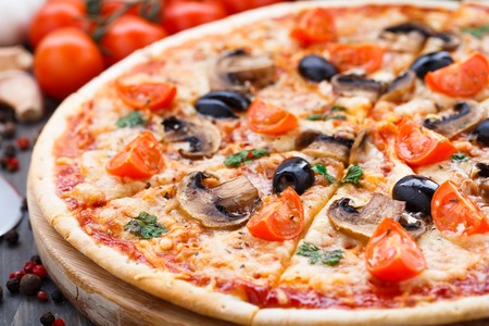 Vegetarian pizza with cherry tomatoes mushroom and olivesの写真素材