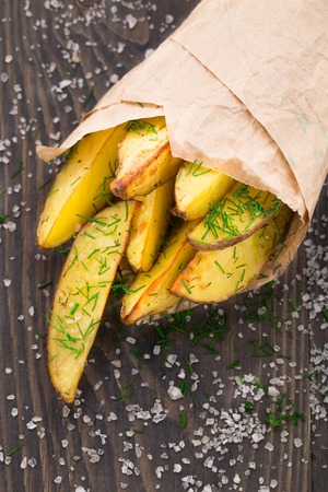 Potato wedges in a parchment paper cornetの写真素材