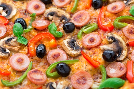 Sausage pizza with mushroom, paprika and olivesの写真素材