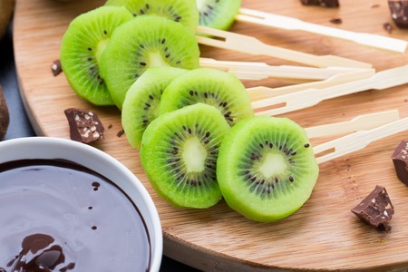 Fresh fruits with chocolate on a stickの写真素材