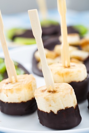 Fresh banana with chocolate on a stickの写真素材