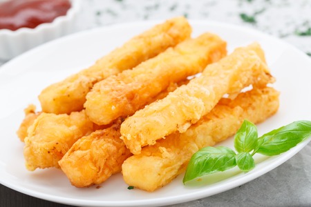 Delicious deep fried cheese sticks on a plateの写真素材