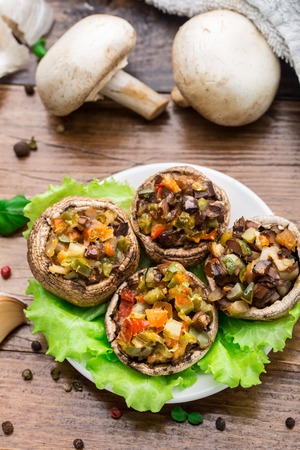 Portobello mushrooms stuffed with tomato, paprika, and mozzarella cheese.の写真素材