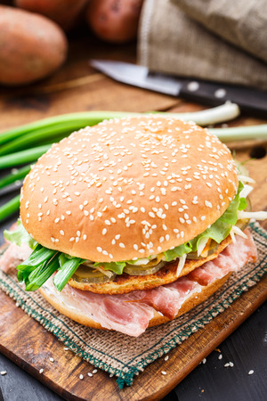 Burger with potato pancake and baconの写真素材
