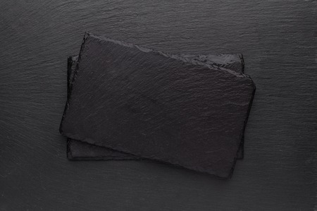 Black slate boards on dark backgroundの写真素材