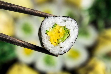 Chopsticks hold vegetarian rollの写真素材