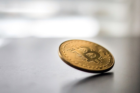 Single bitcoin front coin spinning falling down