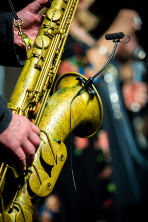 Saxophone player performing on the stage at nightの写真素材