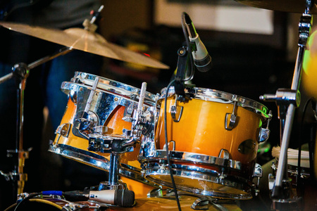 Drum Set with plates and sticks during the concert closeの写真素材