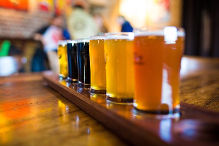 A variety set of craft beers light and dark on the tableの写真素材