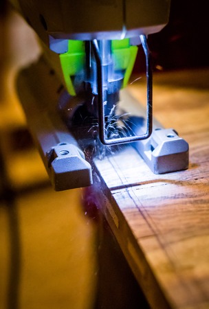 Carpenter at work with wood saw and lightの写真素材