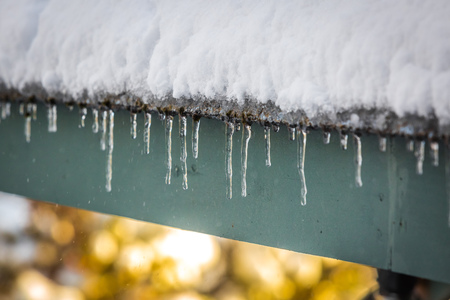 Roof icicles melting in springの写真素材