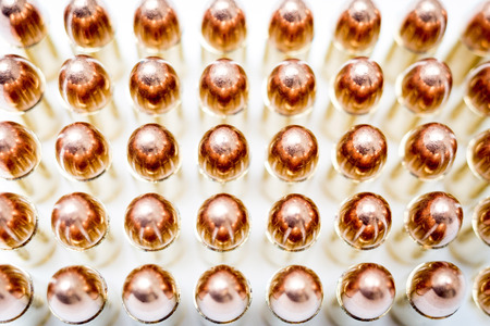Handgun ammo rounds close up bronze on white backgroundの写真素材