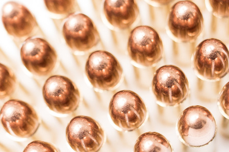 handgun ammo rounds close up bronze on white backgroundの写真素材