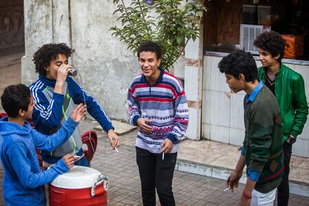 Cairo, Egypt - 29/12/2014: Kids smoking on the street