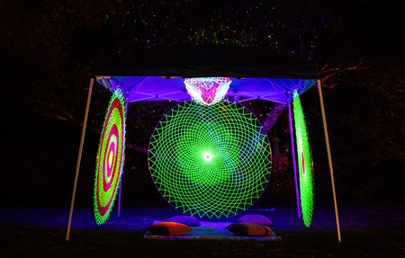 Mandala meditating glowing patterns in the nightの写真素材