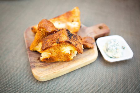 Grilled breakfast toasts with cheese on wooden plateの写真素材