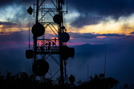 Telecommunication transmitting tower at dawn on top mountainの写真素材