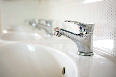Water faucets with white sinks in the bathroom