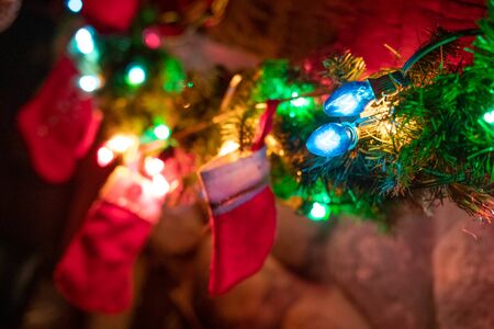 Christmas decoration with color lights and socks fireplaceの写真素材