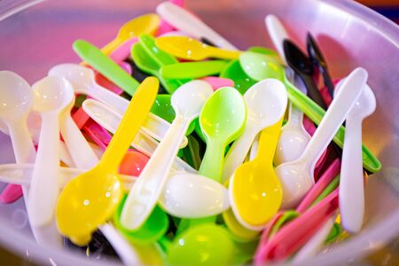 Colourful plastic spoons to recycle and stop pollutionの写真素材