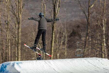 Skier jumping and having fun at resork in winter form the back in the air