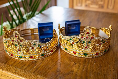 Pair of wedding rings in cases with holy crowns orthodox wedding traditionの写真素材