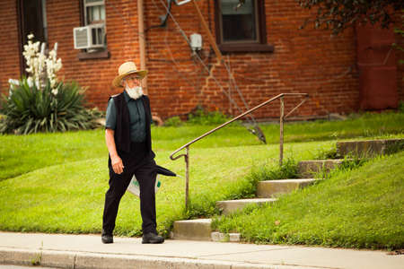 Lancaster, PA / USA - 7/4/2013: Old amish man walking on the street alone at dayのeditorial素材