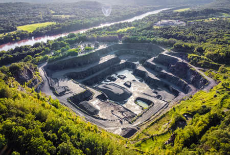 Aerial view of opencast mining quarry in the middle of the forest nobodyの写真素材