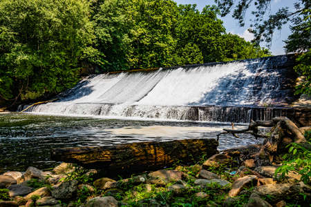 Small scenic river dam in the forest at summer day hiking destinationの写真素材