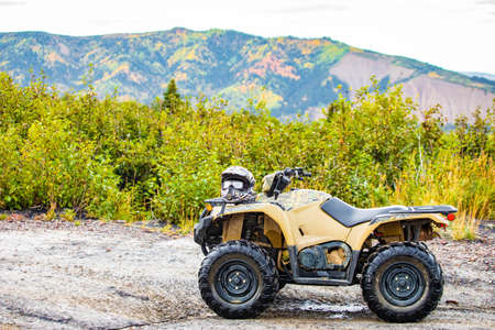 Dirty ATV with scenic background perfect for off road adventures at daylight