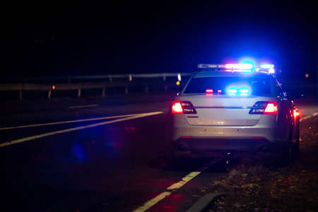 Police emergency flash lights at night from the backの写真素材