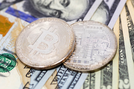 Bitcoin crypto currency on dollar notes close up new currency symbol