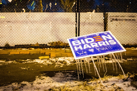 Washington, DC, USA - Feb. 14, 2020: Biden Harris elections sign frozen in front of the fence...