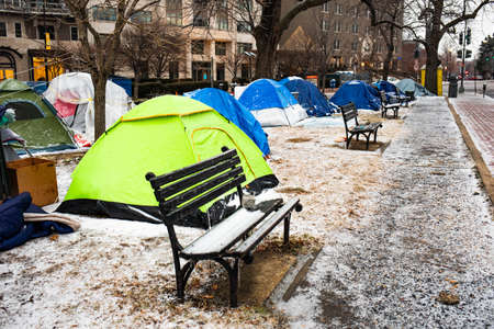 Washington, DC, USA - Feb. 14, 2020: homeless tents covered in ice in winter in the middle of the...