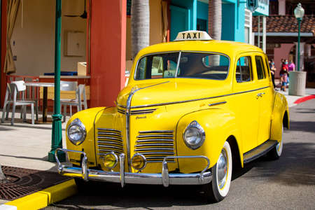 Orlando, USA - Feb. 12, 2021: Orlando, USA - Feb. 12, 2021: Vintage yellow cab taxi parked along the street roadのeditorial素材
