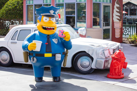 Orlando, USA - Feb. 12, 2021: Chief Clancy Wiggum policeman statue in front of his car