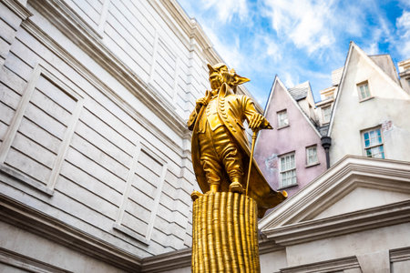 Orlando, USA - Feb. 12, 2021: Golden statue of gringotts goblin on coins at Harry Potter theme parkのeditorial素材