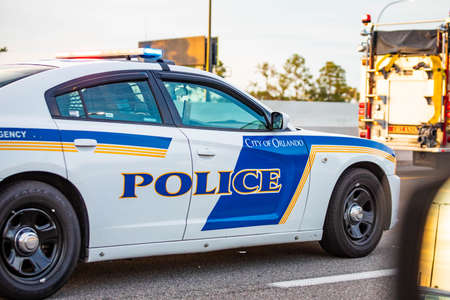 Orlando, USA - Feb. 12, 2021: Orlando police car on the road at dayのeditorial素材