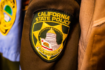 California police clothes batch logo on uniform close up
