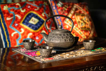 Traditional asian tea ceremony cast iron set with oriental backgroundの写真素材