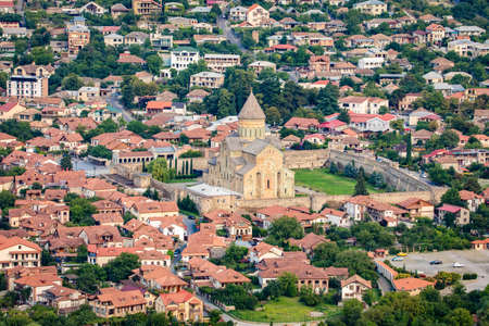 Beautiful view of streets of Mtskheta village in Georgia with Svetitskhoveli Cathedral fortress in the centerの写真素材