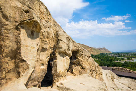 Ancient caves city build in rocks in Uplistsikhe Georgia at daylightの写真素材