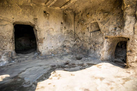 Ancient caves city build in rocks in Uplistsikhe Georgia at daylightの写真素材