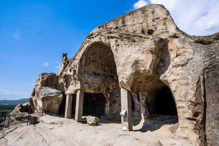 Ancient caves city build in rocks in Uplistsikhe Georgia at daylightの写真素材