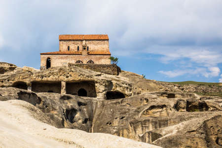 Ancient church monastery in caves city build in rocks in Uplistsikhe Georgia at daylightの写真素材