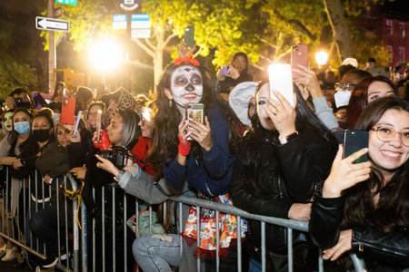 New York, NY - October 31, 2021: Mexian sculls Dia de los muertos costumes at NYC Village Halloween paradeのeditorial素材