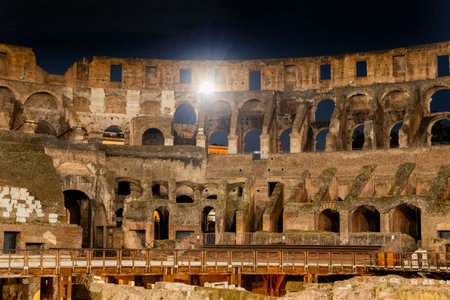 Amazing colosseum stadium interior illuminated at night at Romeの写真素材